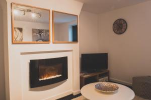 a living room with a fireplace and a tv at Peaceful Retreat Suite - Simple2let Serviced Apartments in Halifax
