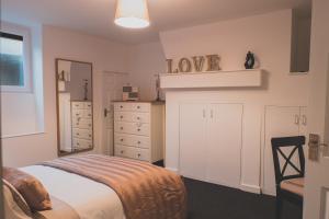 a bedroom with a bed and a dresser at Peaceful Retreat Suite - Simple2let Serviced Apartments in Halifax
