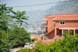a building with a view of the water and a cruise ship at Apartman Stefan in Kotor