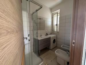 a bathroom with a toilet and a sink and a shower at Casa Vacanza Riviera dei Saraceni in Trebisacce