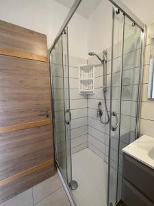 a bathroom with a glass shower with a sink at Casa Vacanza Riviera dei Saraceni in Trebisacce