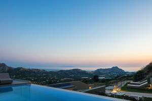 a view of the ocean from a villa at Epsilon Villa, Private Swimming Pool Garden, Panoramic Sunset in Rethymno