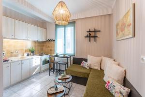 a living room with a couch and a kitchen at La Calma in Argostoli