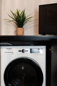 a washing machine with a plant on top of it at La Calma in Argostoli