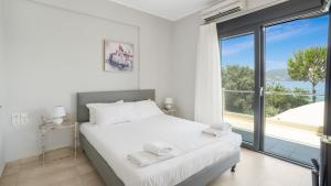 a bedroom with a bed and a large window at Agni Suites in Nikiana