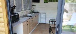 a small kitchen with a sink and a microwave at L escale jardin in Boussay