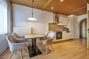 a kitchen and dining room with a table and chairs at Landhaus Huber in Altenmarkt im Pongau