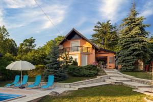 a house with a swimming pool and chairs at Villa Tratea - With Pool in Tomić Draga