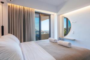a bedroom with a bed with two towels on it at Sigma Villa, Private Swimming Pool Garden, Panoramic Sunset in Rethymno Town +52 photos