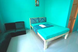 a blue room with a bed and a chair at Peaceful and Calm place in Lucena