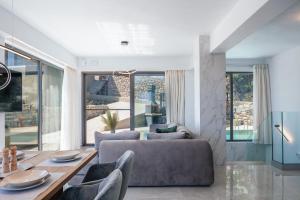 a living room with a couch and a table at Sigma Villa, Private Swimming Pool Garden, Panoramic Sunset in Rethymno Town
