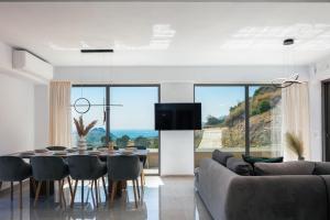 a dining room with a table and a couch at Sigma Villa, Private Swimming Pool Garden, Panoramic Sunset in Rethymno Town