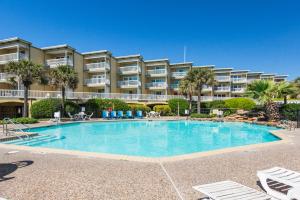 a large swimming pool in front of a building at Beachfront Haven in Galveston