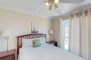 a bedroom with a bed and a window at Beachfront Haven in Galveston +15 photos