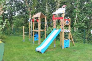 a playground with a blue slide and a slideintend at Greenways Valley Holiday Park in Great Torrington