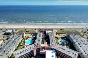 an aerial view of a beach with hotels and the ocean at Beachfront Haven in Galveston