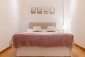 1 dormitorio blanco con 1 cama grande y 2 almohadas en Amazing apartment in Huertas, en Madrid