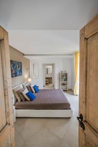 a bedroom with a large bed with blue pillows at Villa Lilia in Vietri sul Mare