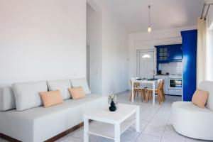 a living room with a white couch and a table at Koroni Xenios Zeus, Seaview Summer Retreats in Koroni