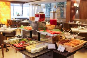 a buffet of food on a table in a restaurant at CENTRAL A BOUTIQUE HOTEL in Belgaum