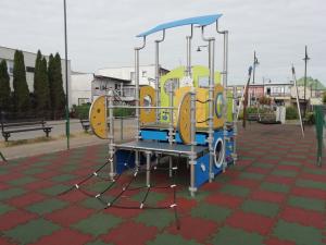 a playground in a park with a play equipment at Pokoje przy fontannie in Karwia