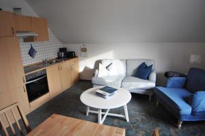 a small living room with a couch and a table at Ferienwohnung Bohlen 65265 in Moormerland