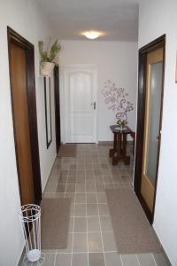 a hallway with a tile floor and a door at Apartman Mara in Sveti Juraj
