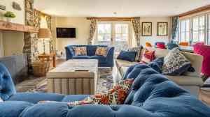 a living room with blue couches and a fireplace at Bull Pen in Rusland