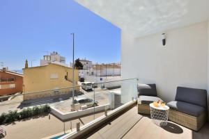 a living room with a couch on a balcony at The Hub central apartment Burgau in Burgau