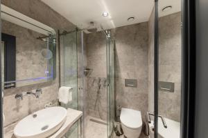 a bathroom with a sink and a shower at AHG Atlas Hotel Taksim in Istanbul