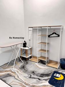 a room with a white desk and a shelf at Rz Homestay in Malacca