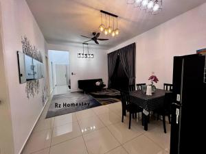 a living room with a table and a dining room at Rz Homestay in Malacca