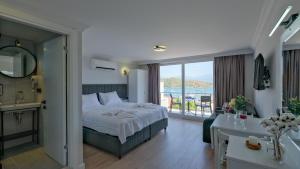 a hotel room with a bed and a balcony at Miralya Rooms in Fethiye +36 photos