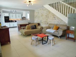 ein Wohnzimmer mit 2 Sofas und einem Tisch in der Unterkunft Le Cottage des 3 Pignons in Noisy-sur-École