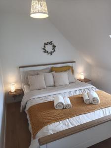 a bedroom with a bed with two towels on it at La Ferme de Penanguer in Loctudy