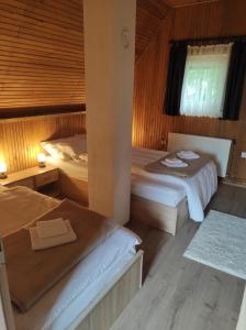 1 dormitorio con 2 camas y ventana en Kuća za odmor Iva, en Lič
