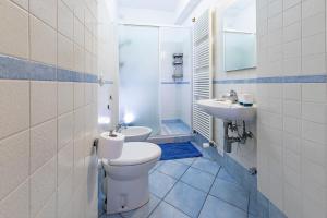 a bathroom with a toilet and a sink at Residenza Palazzo Marchesini in Bologna