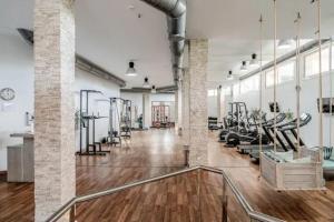 a gym with treadmills and elliptical machines at 5* Serviced Apartment Marbella in Marbella