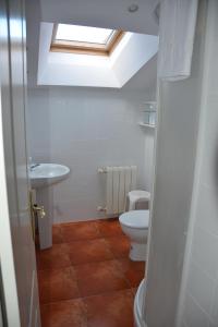 a bathroom with a toilet and a sink and a skylight at For You Rentals Preciosa Buhardilla en plena Puerta del Sol de Madrid COR2 in Madrid