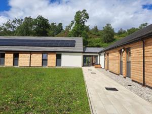a house with solar panels on the roof at An Spiris Accommodation at Dundreggan Rewilding Centre in Dundreggan