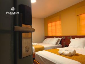 Cama o camas de una habitación en Hoteles Paraiso CHICLAYO