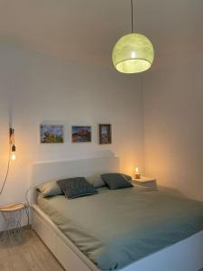 a bedroom with a large bed with a green blanket at Terra Teatina B&B in Chieti +13 photos