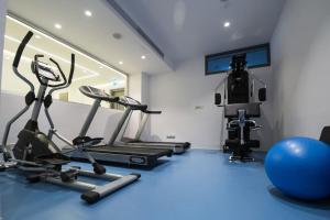 a gym with two exercise bikes and a gym ball at Fig Tree Island Apartment-144 in Protaras