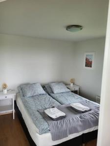 1 dormitorio con 1 cama con 2 toallas en Hólar Countryside Cabin 2 en Selfoss