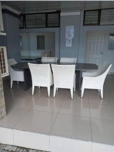a table and chairs with a table and a table and chairs at THK Properties in Pretoria
