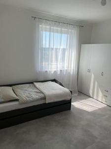 um quarto com uma cama e uma grande janela em Charmante Ferienwohnung mit Klimaanlage ! em Mainaschaff