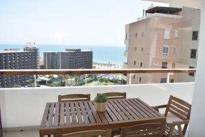- une table en bois sur un balcon avec vue sur l'océan dans l'établissement Mirador Torres de Playamar, con vistas al mar, à Torremolinos