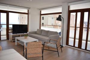 - un salon avec un canapé et une télévision dans l'établissement Mirador Torres de Playamar, con vistas al mar, à Torremolinos