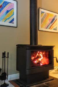 a fireplace in a living room with a fire in it at Angaston Lodge in Angaston