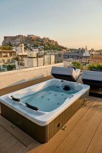 a hot tub on the roof of a building at Eclectic Acropolis Rooftop Loft in Athens